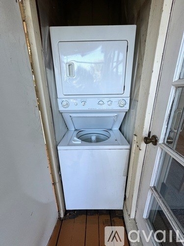 A white washing machine is in a small space.