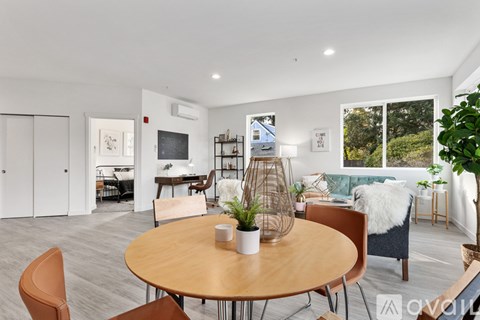 A living room with a round table and chairs.