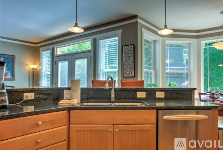 A kitchen with wooden cabinets and a black countertop.