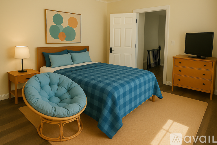 A bedroom with a bed, a chair, a nightstand, and a television.