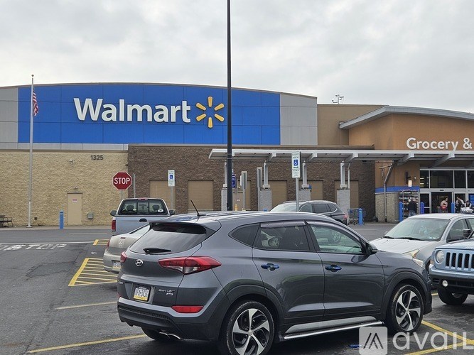 A Walmart store with a parking lot in front.