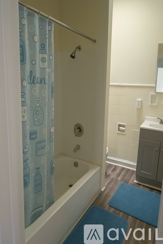 A bathroom with a shower curtain that says "clean" on it.