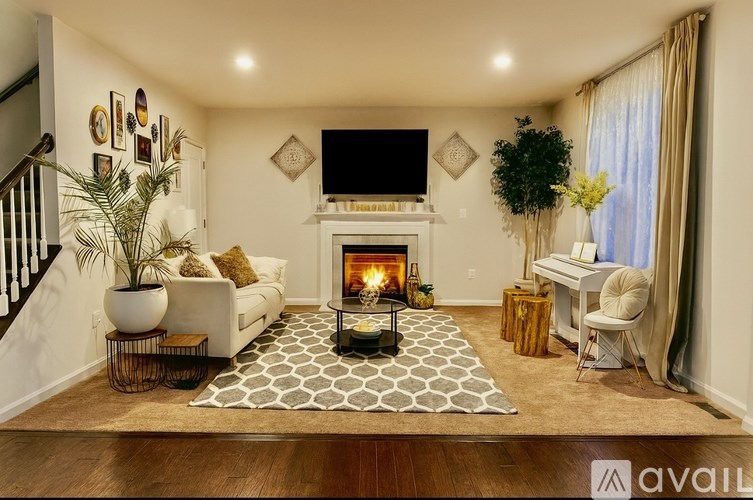 A living room with a fireplace and a television mounted on the wall.