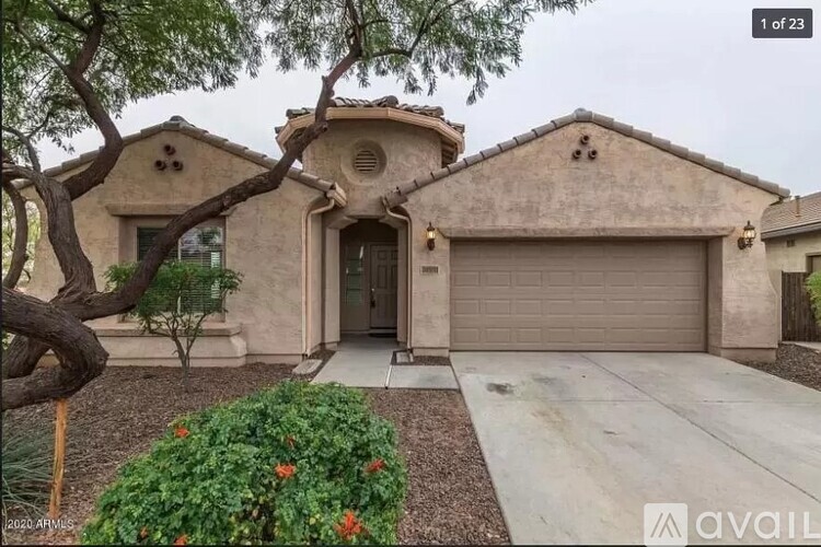 A house with a beige exterior and a garage door is for sale.