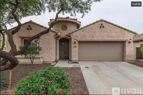 A house with a beige exterior and a garage door is for sale.