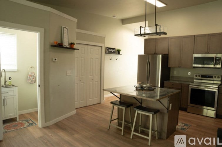 A kitchen with a table and chairs in the middle of the room.