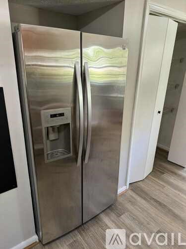 A kitchen with wooden cabinets and black appliances.