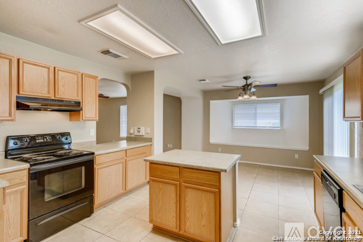 A kitchen with wooden cabinets and a black stove top oven.