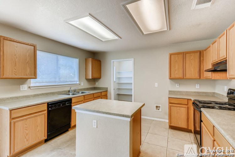 A kitchen with wooden cabinets and a white refrigerator.