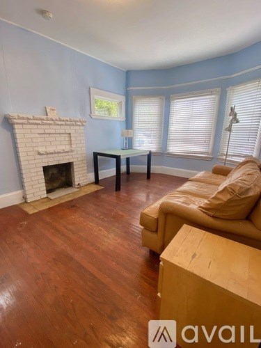 A living room with a fireplace and a couch.