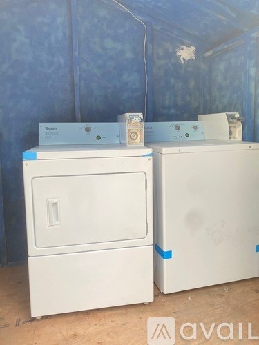 A white oven and dishwasher are on a counter.