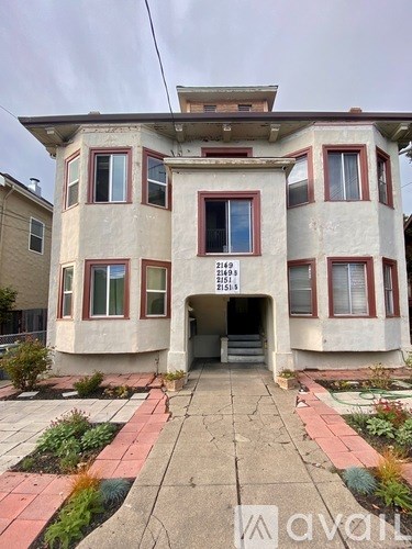 A two-story house with a red brick border around the windows and doors.