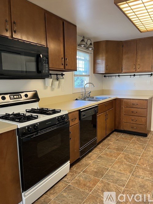 A room with two doors and carpeted floor.