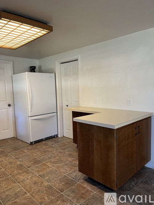 A bathroom with blue walls and a white toilet.