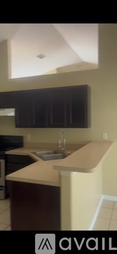 A kitchen with a sink and a counter.