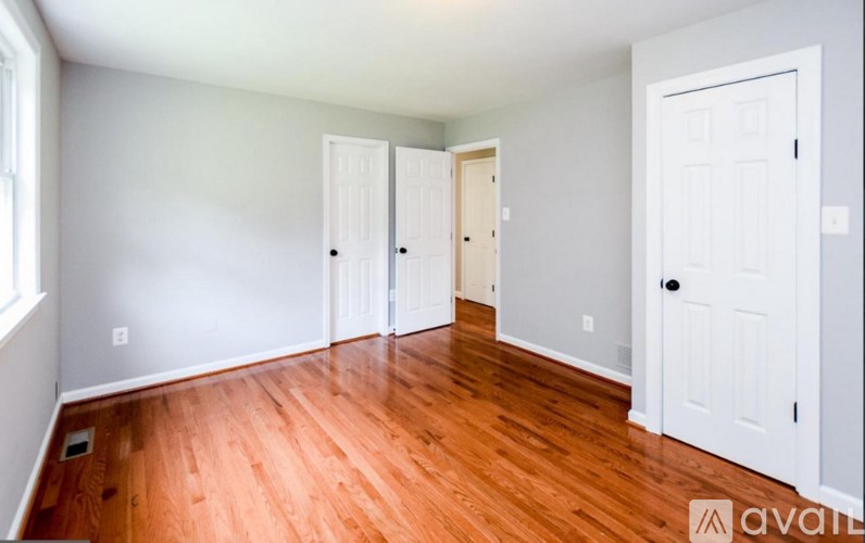 A room with wooden floors and white walls.
