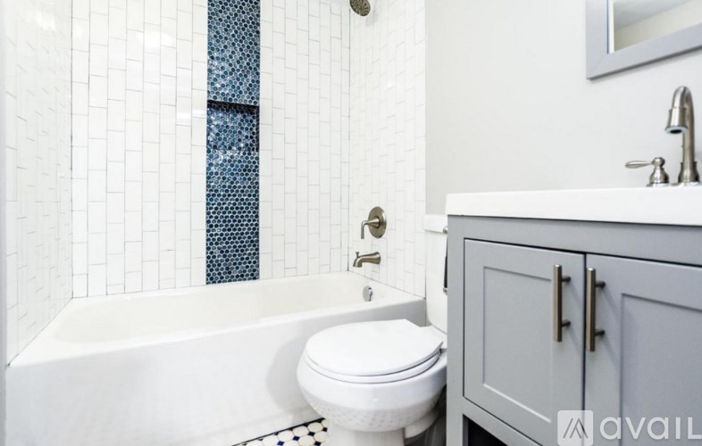 A white toilet sits next to a bathtub in a bathroom.