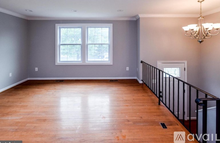 A room with wooden floors and a chandelier.