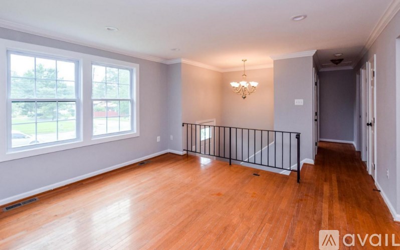 A room with wooden floors and a chandelier.