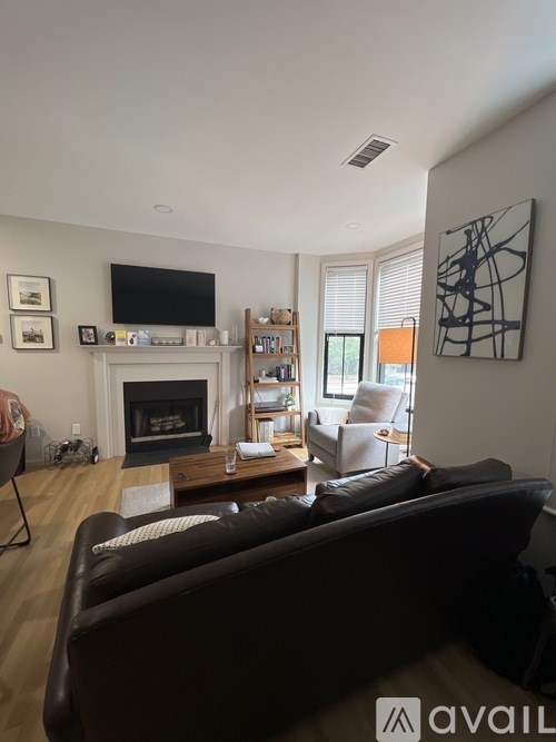 A living room with a fireplace and a couch.