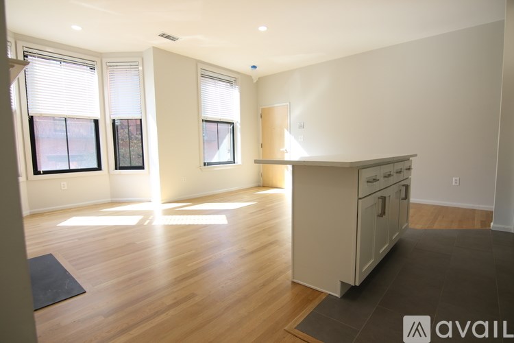 A kitchen area with wooden floors and a large island.