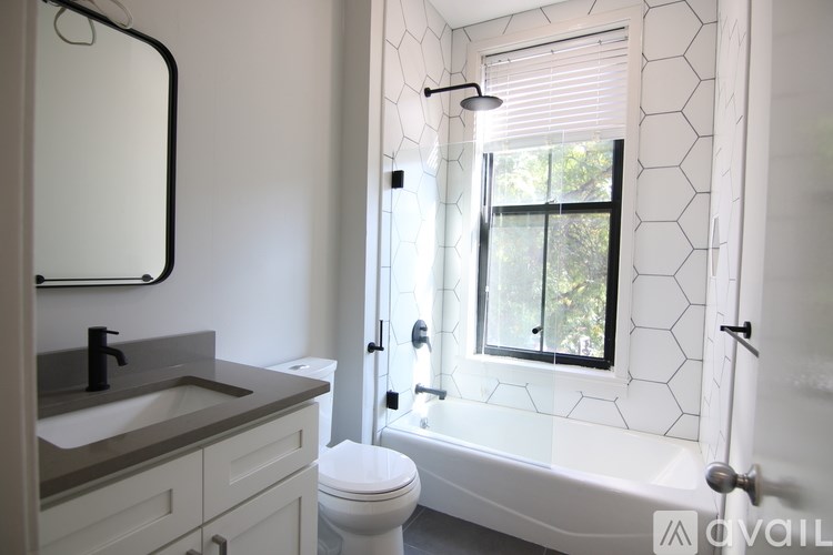 A bathroom with a white toilet, sink, and bathtub.