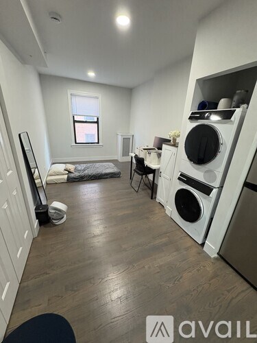 A small room with a washing machine and dryer built into the cabinetry.