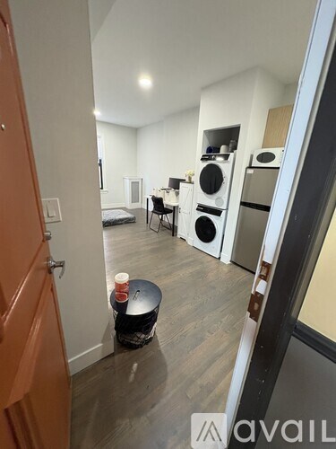 A kitchen area with a table and chairs in the middle of the room.