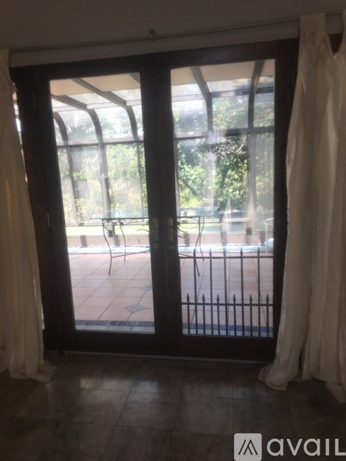 A patio with a table and chairs is visible through a sliding glass door.