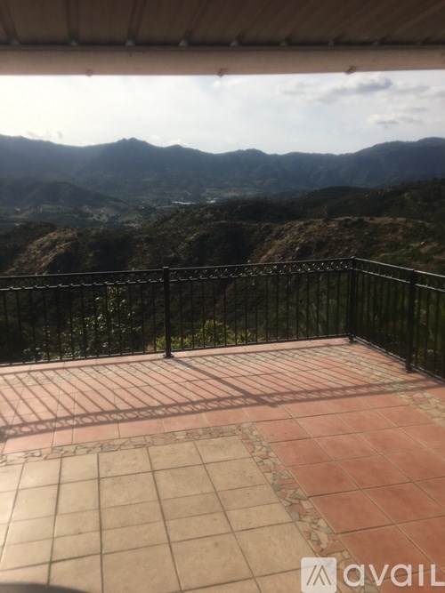 A balcony with a view of the mountains.