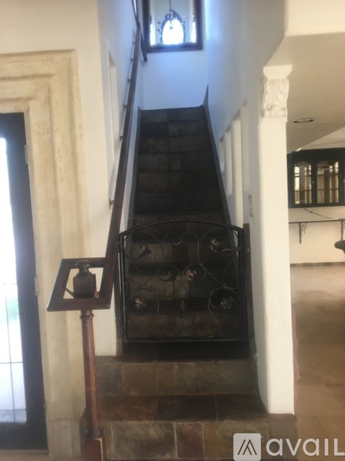 A staircase with a metal railing and a lantern on top.