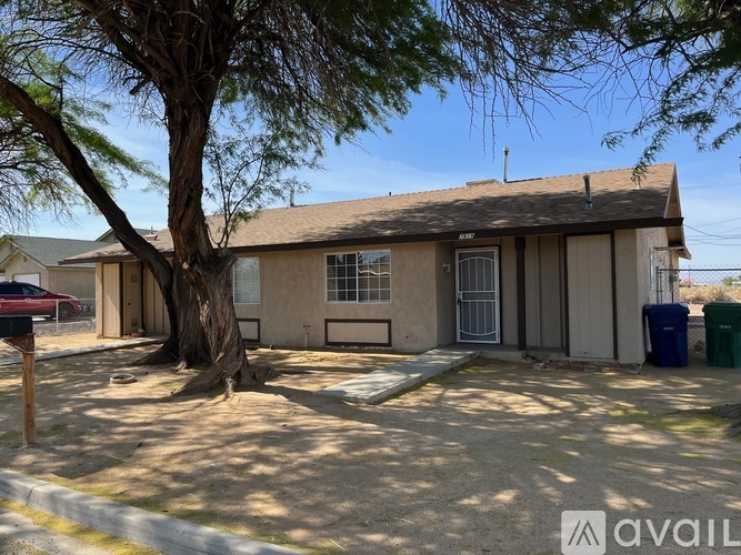 A house with a tree in front of it is for sale.