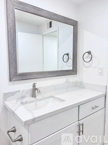 A bathroom with a sink and a mirror.