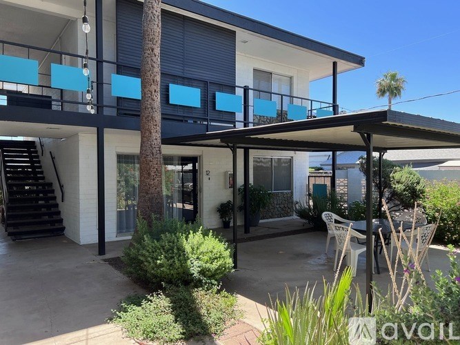 A modern house with a balcony and a patio area.