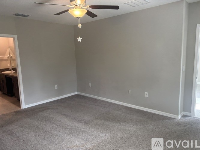 A room with a ceiling fan and a star decoration hanging from the ceiling.