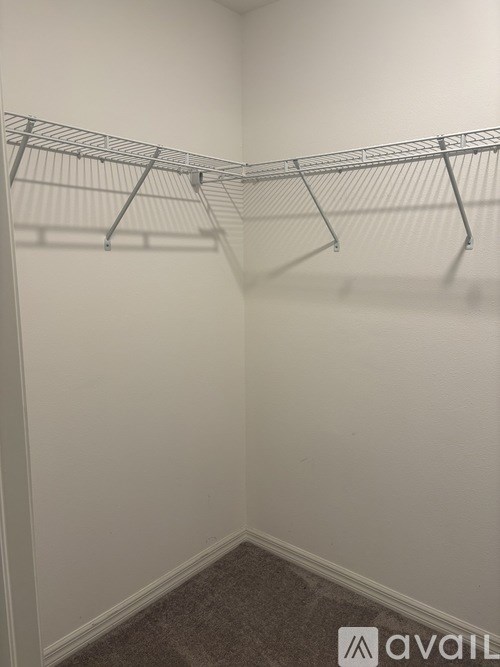A white closet with a metal rack.