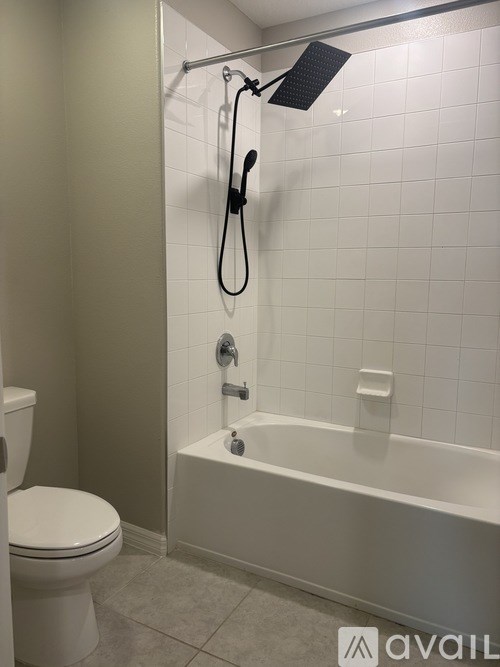 A white toilet is next to a white bathtub in a bathroom.