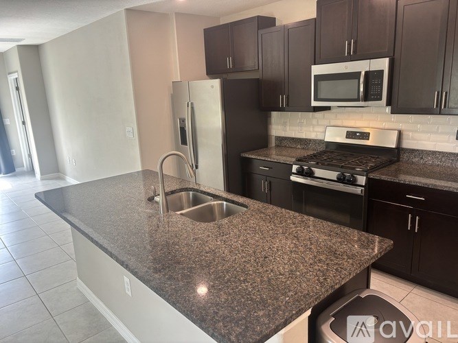 A kitchen with granite countertops and stainless steel appliances.