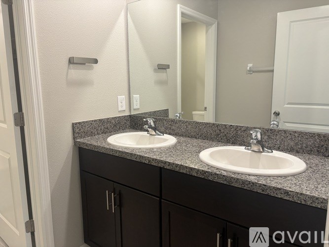 A bathroom with two sinks and a mirror.