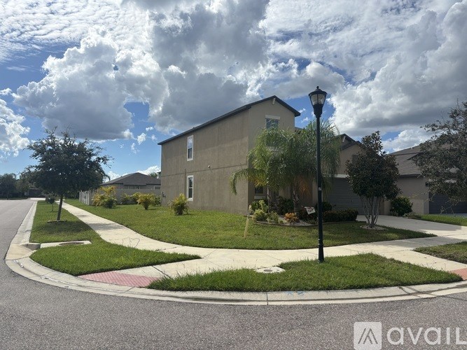 A street view of a residential area with houses and a street lamp.