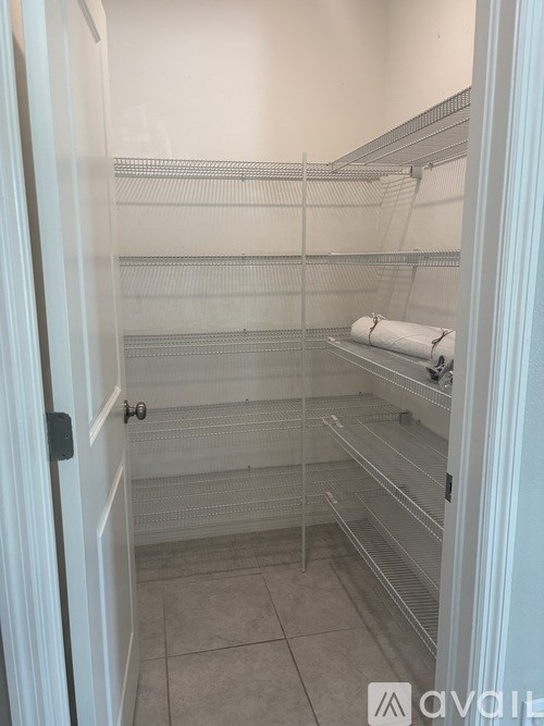 A walk-in closet with shelves and a door.
