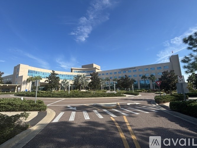 A modern building with a clear blue sky above it.