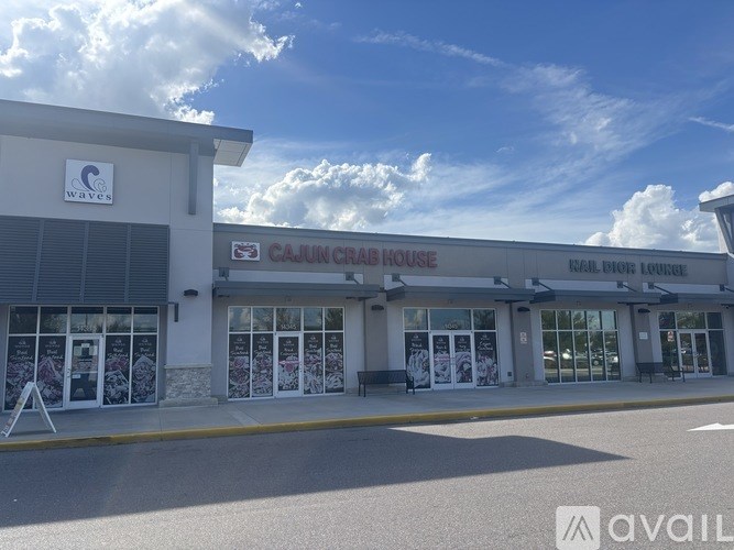 The exterior of a Cajun Crab House restaurant with a clear blue sky in the background.