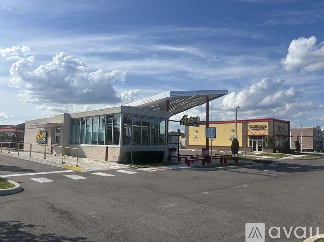 A modern building with a glass facade and a yellow sign that reads "Culver's".