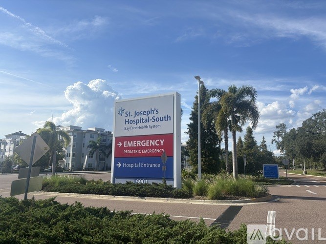 A sign for St. Joseph's Hospital-South by Care Health System with directions to the emergency pediatric emergency and hospital entrance.