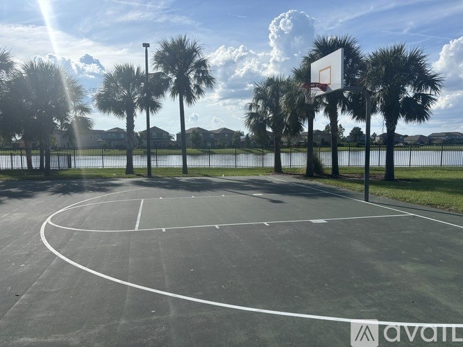 A basketball court with a white hoop and a sign that says "AVAILABLE" in the background.