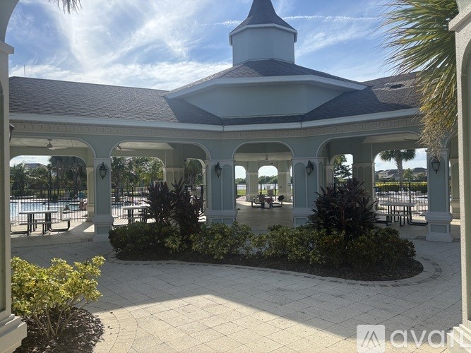 A white building with a dome and a covered walkway.