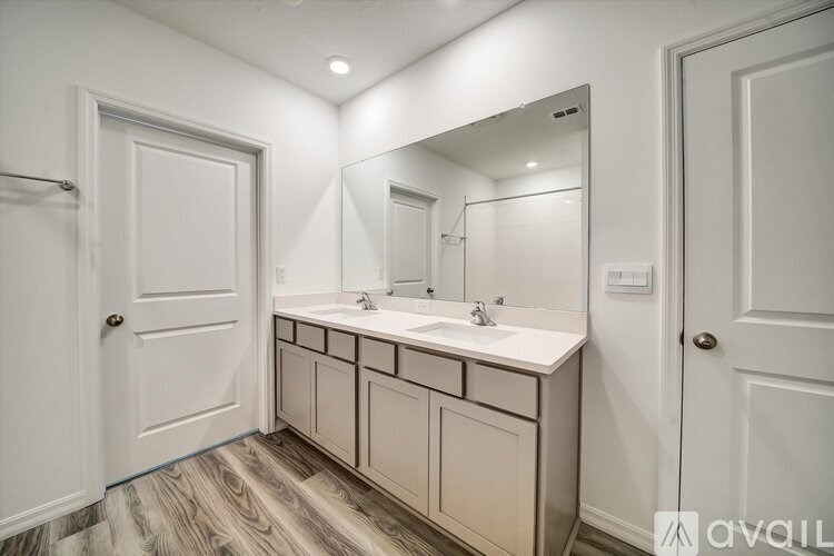 A bathroom with a vanity and a mirror.