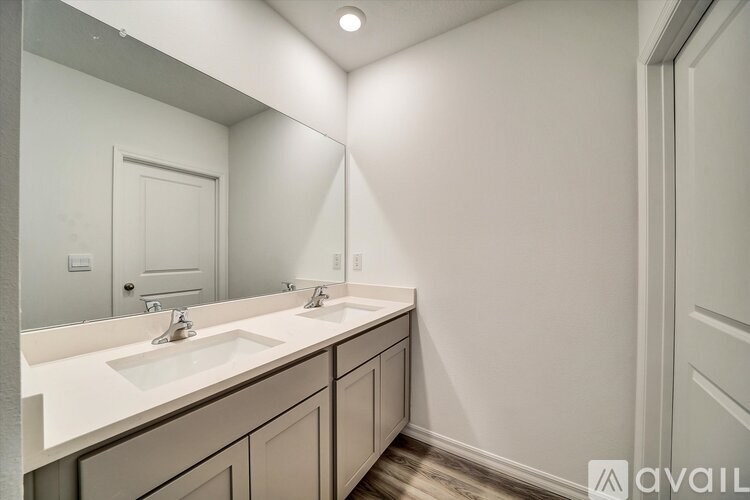 A bathroom with two sinks and a large mirror.