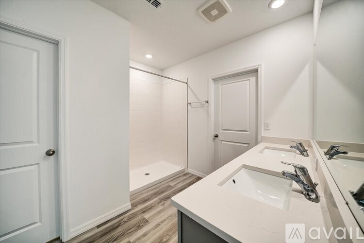 A bathroom with a white sink and a white door.